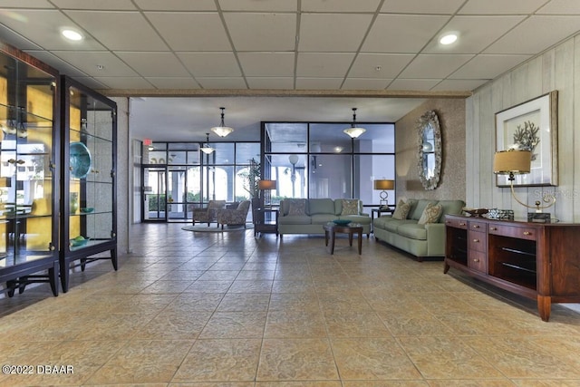 community lobby featuring expansive windows and a paneled ceiling