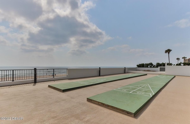 surrounding community with shuffleboard and a water view
