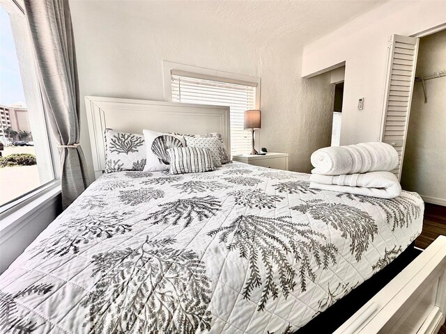 3112 S Atlantic Ave, Daytona Beach, FL 32118 - bedroom with wood finished floors and a textured wall
