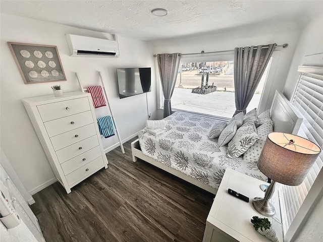 3112 S Atlantic Ave, Daytona Beach, FL 32118 - bedroom featuring a wall mounted air conditioner, dark wood-style floors, baseboards, and a textured ceiling
