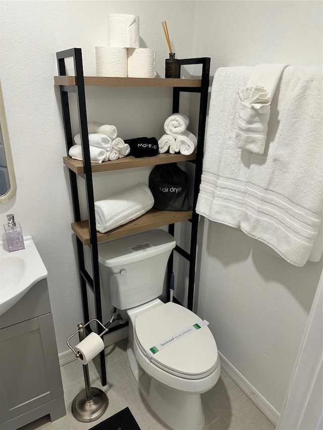 3112 S Atlantic Ave, Daytona Beach, FL 32118 - half bathroom with toilet, vanity, and baseboards