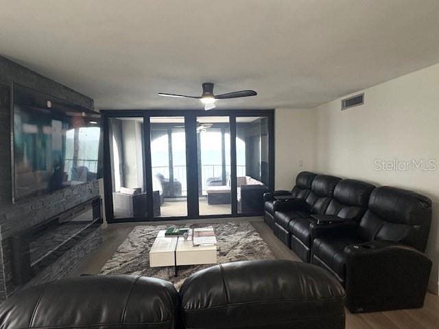 living room with wood finished floors and ceiling fan