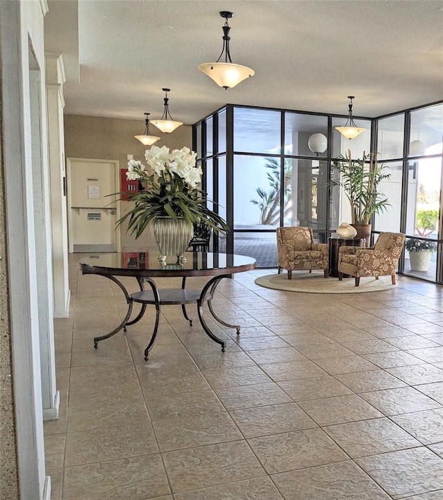 building lobby featuring expansive windows and a textured ceiling