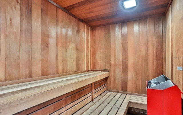 sauna with wood ceiling and wood walls