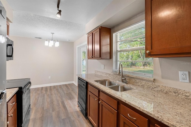 541 Northwestern Ave, Altamonte Springs, FL 32714 - kitchen with a sink, black appliances, light wood finished floors, baseboards, and a chandelier
