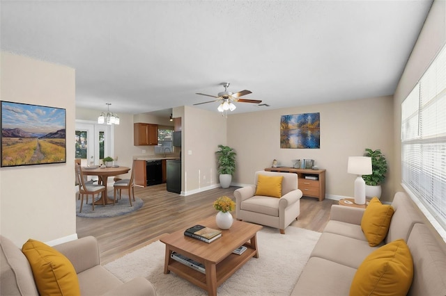 541 Northwestern Ave, Altamonte Springs, FL 32714 - living room featuring baseboards, light wood-style floors, a chandelier, and ceiling fan