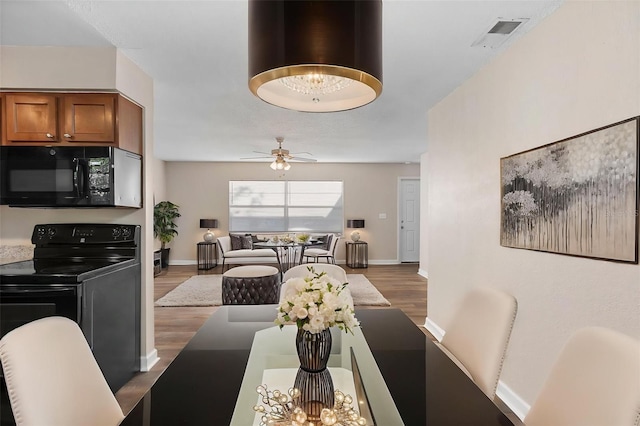 541 Northwestern Ave, Altamonte Springs, FL 32714 - dining area with ceiling fan, wood finished floors, and baseboards