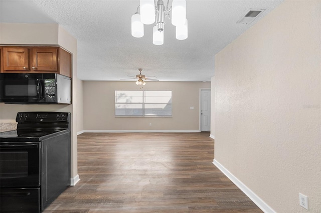 541 Northwestern Ave, Altamonte Springs, FL 32714 - kitchen with black appliances, brown cabinets, a textured ceiling, a chandelier, and dark wood-type flooring