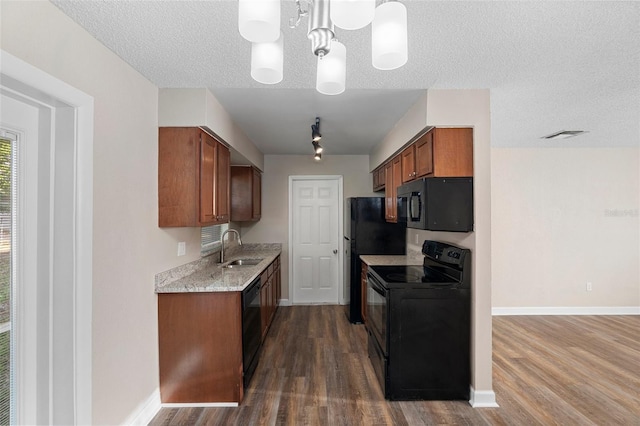 541 Northwestern Ave, Altamonte Springs, FL 32714 - kitchen with black appliances, a sink, dark wood-type flooring, baseboards, and light stone counters