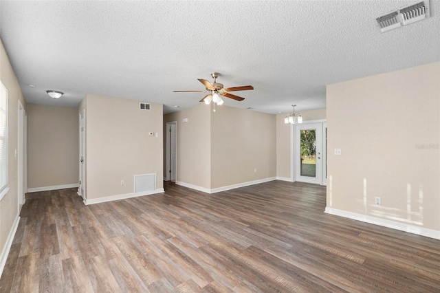 541 Northwestern Ave, Altamonte Springs, FL 32714 - unfurnished living room featuring ceiling fan, wood finished floors, a textured ceiling, baseboards, and a chandelier