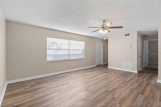 541 Northwestern Ave, Altamonte Springs, FL 32714 - empty room with a ceiling fan, wood finished floors, baseboards, and a textured ceiling