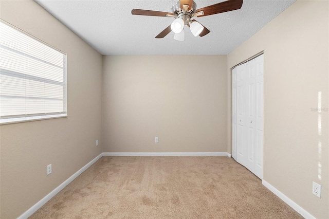 541 Northwestern Ave, Altamonte Springs, FL 32714 - unfurnished bedroom with light carpet, a closet, a textured ceiling, baseboards, and a ceiling fan
