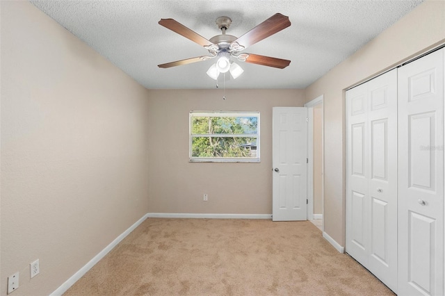 541 Northwestern Ave, Altamonte Springs, FL 32714 - unfurnished bedroom featuring light carpet, baseboards, a closet, a textured ceiling, and ceiling fan