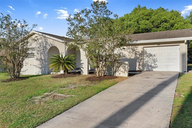 541 Northwestern Ave, Altamonte Springs, FL 32714 - view of front facade featuring a garage, driveway, stucco siding, and a front lawn