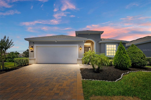 518 Briarbrook Way, Deland, FL 32724 - view of front of home with a garage, stucco siding, and decorative driveway