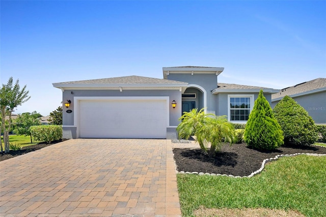 518 Briarbrook Way, Deland, FL 32724 - view of front of property with an attached garage, stucco siding, and decorative driveway