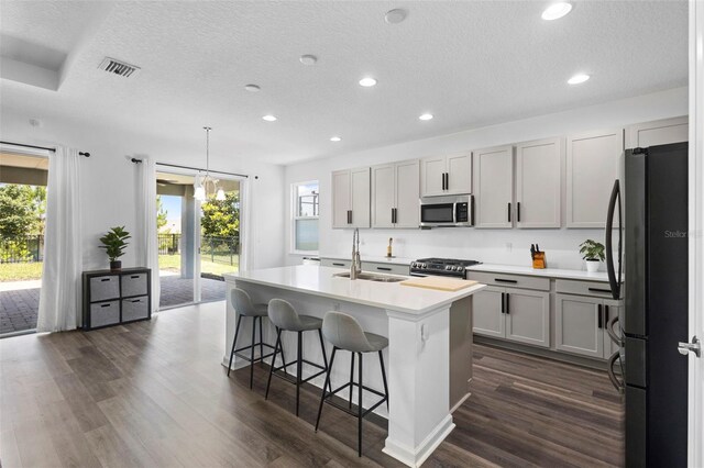 518 Briarbrook Way, Deland, FL 32724 - kitchen featuring stainless steel appliances, a sink, recessed lighting, a textured ceiling, and dark wood finished floors