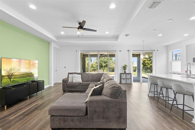 518 Briarbrook Way, Deland, FL 32724 - living area featuring a tray ceiling, dark wood-style floors, a ceiling fan, recessed lighting, and a textured ceiling