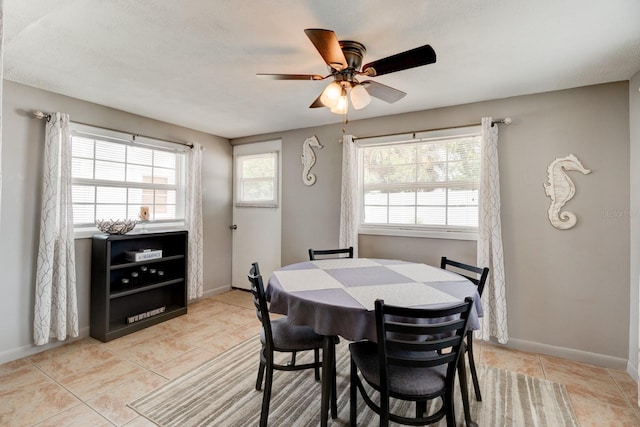 26 Ocean Shore Dr, Ormond Beach, FL 32176 - dining area with light tile patterned floors, a ceiling fan, and baseboards