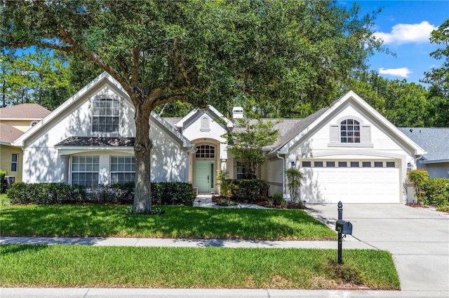 1412 Bent Oaks Blvd, Deland, FL 32724 - view of front of house with an attached garage, stucco siding, driveway, and a front yard