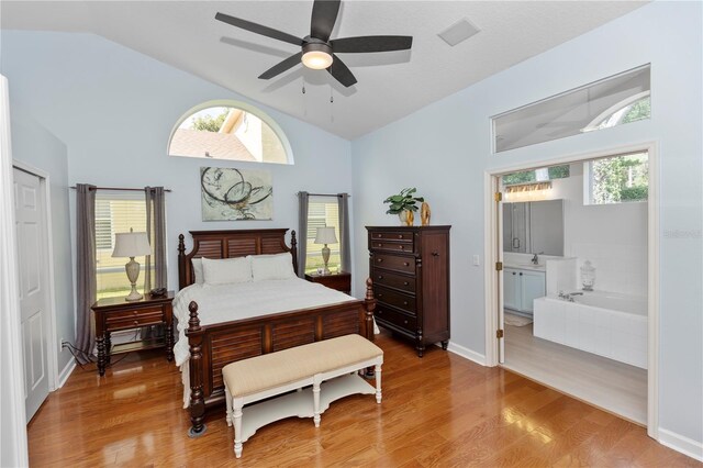 1412 Bent Oaks Blvd, Deland, FL 32724 - bedroom with multiple windows, light wood finished floors, ensuite bath, and high vaulted ceiling