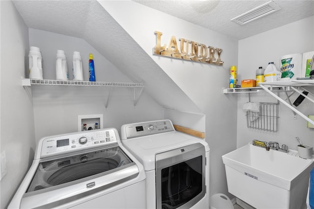 1412 Bent Oaks Blvd, Deland, FL 32724 - laundry area with separate washer and dryer and a textured ceiling