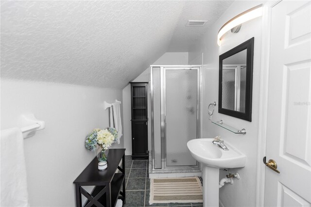 1412 Bent Oaks Blvd, Deland, FL 32724 - bathroom featuring a textured ceiling, a stall shower, lofted ceiling, and tile patterned flooring