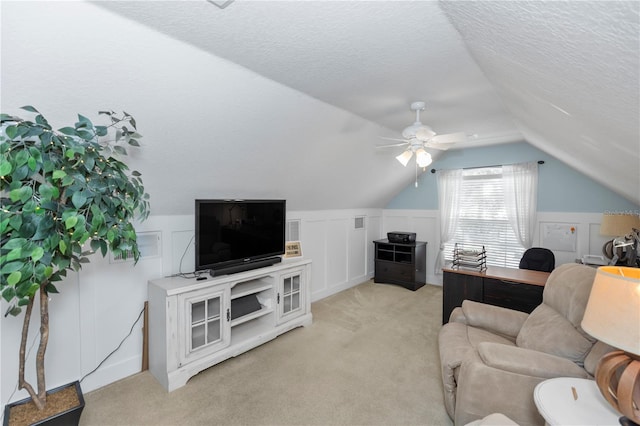 1412 Bent Oaks Blvd, Deland, FL 32724 - living room featuring vaulted ceiling, a decorative wall, light carpet, a textured ceiling, and a ceiling fan