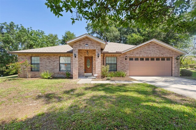 1120 W Glen Falls Rd, Deland, FL 32720 - ranch-style home with brick siding, a garage, a front lawn, and concrete driveway