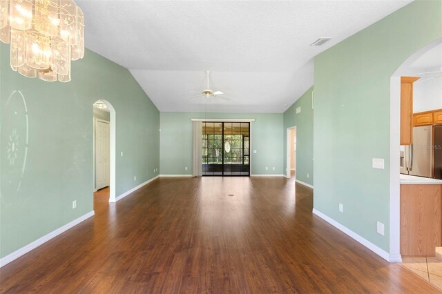 1120 W Glen Falls Rd, Deland, FL 32720 - unfurnished living room featuring arched walkways, ceiling fan, wood finished floors, and lofted ceiling