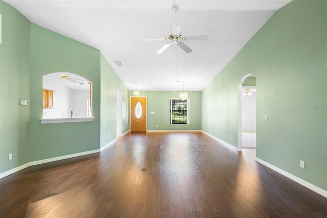 1120 W Glen Falls Rd, Deland, FL 32720 - unfurnished living room featuring a ceiling fan, arched walkways, vaulted ceiling, and wood finished floors