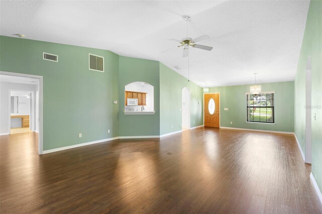 1120 W Glen Falls Rd, Deland, FL 32720 - unfurnished living room with a ceiling fan, wood finished floors, baseboards, arched walkways, and lofted ceiling