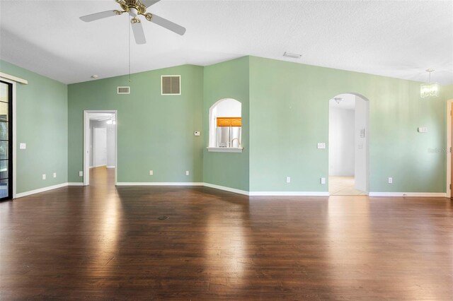 1120 W Glen Falls Rd, Deland, FL 32720 - unfurnished living room with arched walkways, ceiling fan, wood finished floors, lofted ceiling, and baseboards