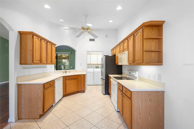 1120 W Glen Falls Rd, Deland, FL 32720 - kitchen featuring white appliances, washer and clothes dryer, ceiling fan, a sink, and light countertops