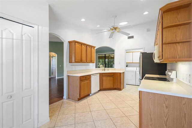 1120 W Glen Falls Rd, Deland, FL 32720 - kitchen with white appliances, washing machine and dryer, a ceiling fan, open shelves, and arched walkways