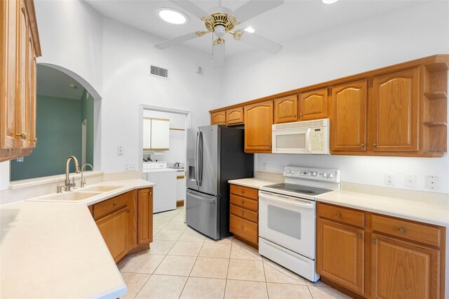 1120 W Glen Falls Rd, Deland, FL 32720 - kitchen featuring white appliances, washer / dryer, a sink, a high ceiling, and a ceiling fan