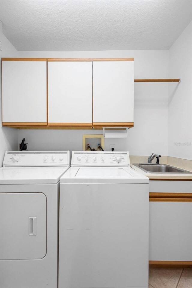 1120 W Glen Falls Rd, Deland, FL 32720 - laundry area with cabinet space, independent washer and dryer, and a textured ceiling