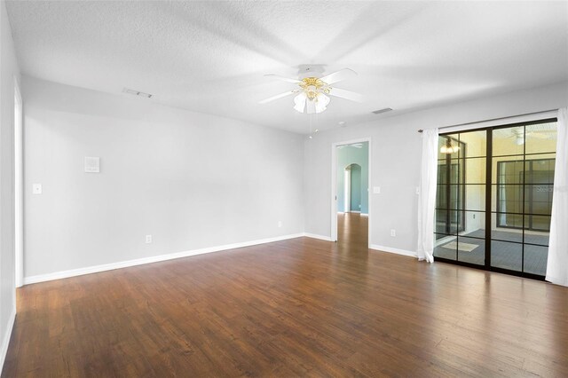 1120 W Glen Falls Rd, Deland, FL 32720 - empty room featuring a ceiling fan, wood finished floors, arched walkways, baseboards, and a textured ceiling