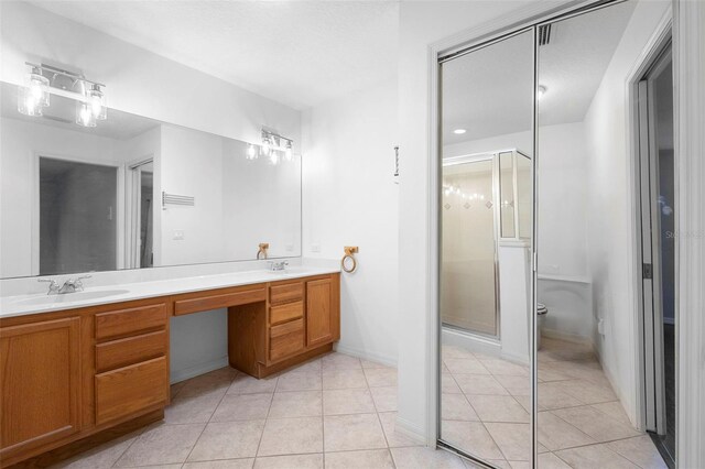 1120 W Glen Falls Rd, Deland, FL 32720 - bathroom with tile patterned floors, double vanity, a stall shower, and baseboards