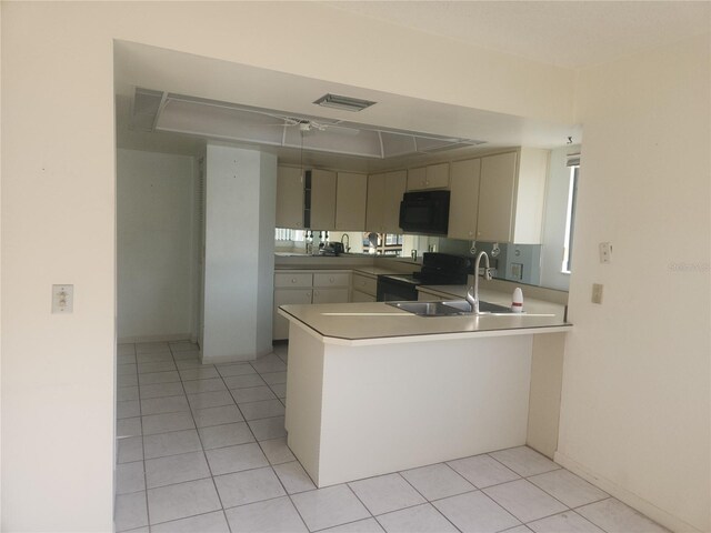8 Oxford Ln, Palm Coast, FL 32137 - kitchen with black appliances, a peninsula, a sink, and light tile patterned flooring