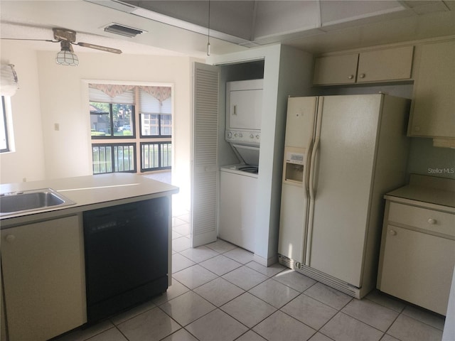8 Oxford Ln, Palm Coast, FL 32137 - kitchen with stacked washer / dryer, dishwasher, white fridge with ice dispenser, light tile patterned floors, and a sink