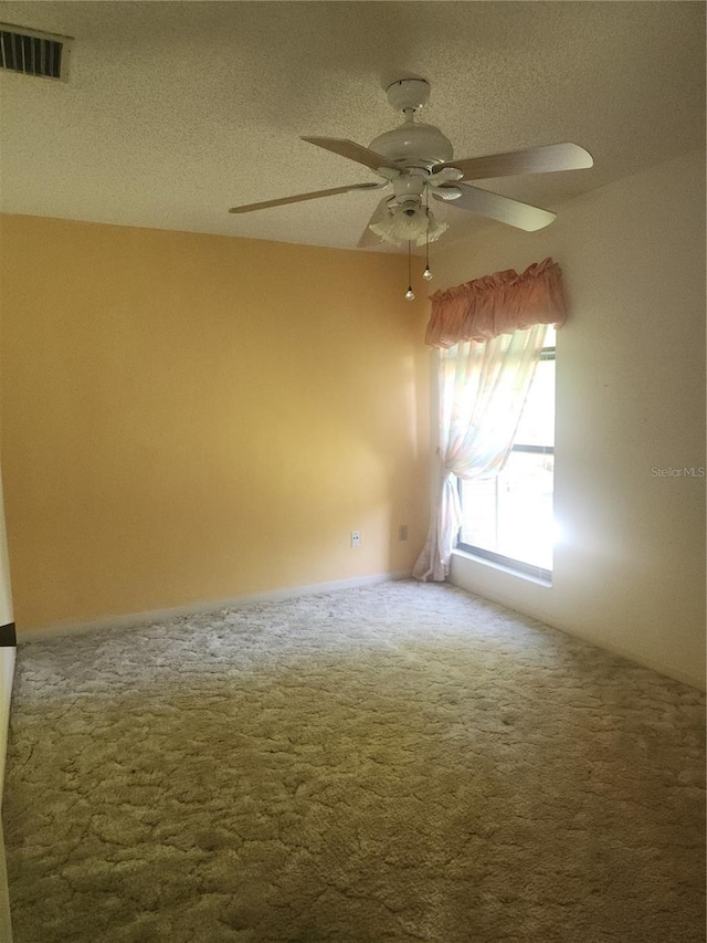 8 Oxford Ln, Palm Coast, FL 32137 - carpeted empty room with a ceiling fan and a textured ceiling