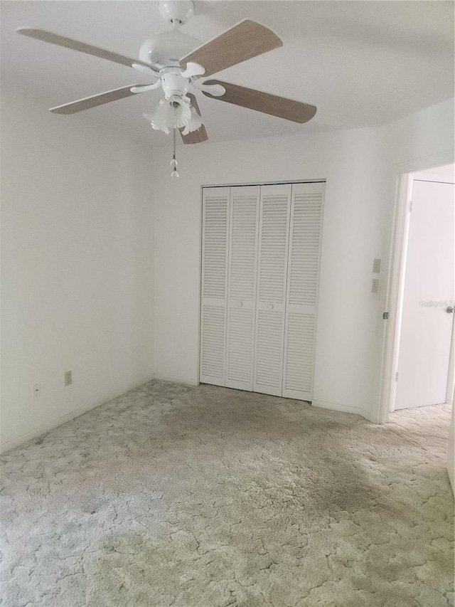 8 Oxford Ln, Palm Coast, FL 32137 - unfurnished bedroom with carpet flooring, a closet, and a ceiling fan
