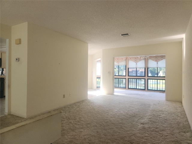 8 Oxford Ln, Palm Coast, FL 32137 - spare room featuring carpet and a textured ceiling