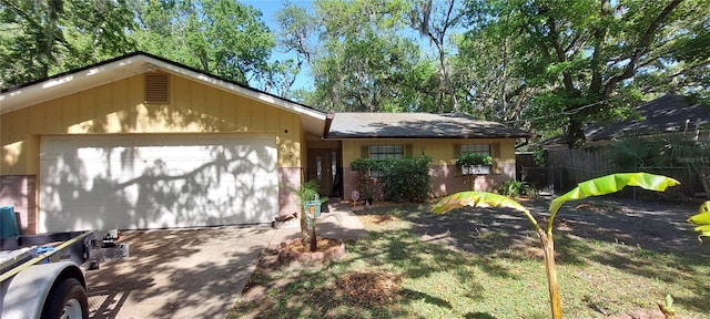 1621 Anniston Ave, Daytona Beach, FL 32117 - view of front of home featuring brick siding, an attached garage, fence, and driveway