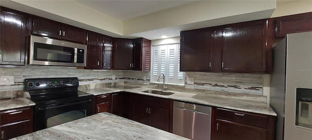 1621 Anniston Ave, Daytona Beach, FL 32117 - kitchen featuring stainless steel appliances, a sink, backsplash, dark brown cabinetry, and light stone counters