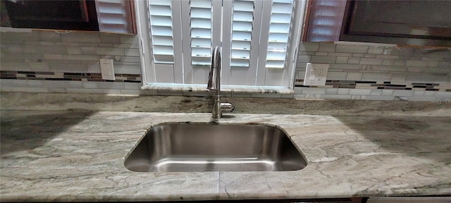 1621 Anniston Ave, Daytona Beach, FL 32117 - kitchen view of a sink, decorative backsplash, and light stone counters
