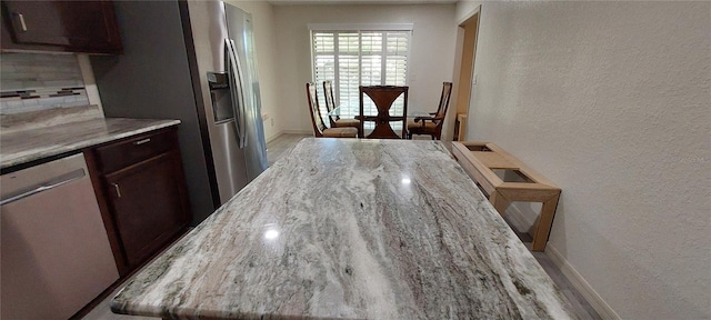 1621 Anniston Ave, Daytona Beach, FL 32117 - kitchen featuring stainless steel appliances, a textured wall, tasteful backsplash, baseboards, and dark brown cabinets