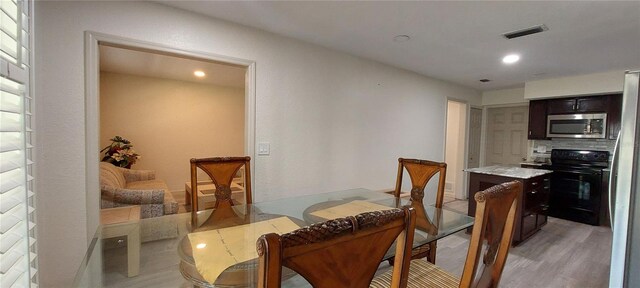 1621 Anniston Ave, Daytona Beach, FL 32117 - dining space featuring light wood-style floors and recessed lighting