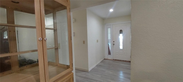 1621 Anniston Ave, Daytona Beach, FL 32117 - foyer entrance with wood finished floors, a textured wall, and baseboards